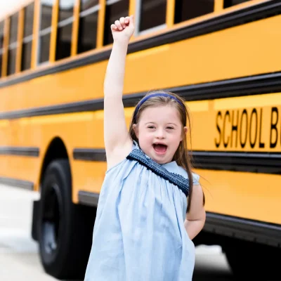 little-girl-raised-fist-school-yellow-bus